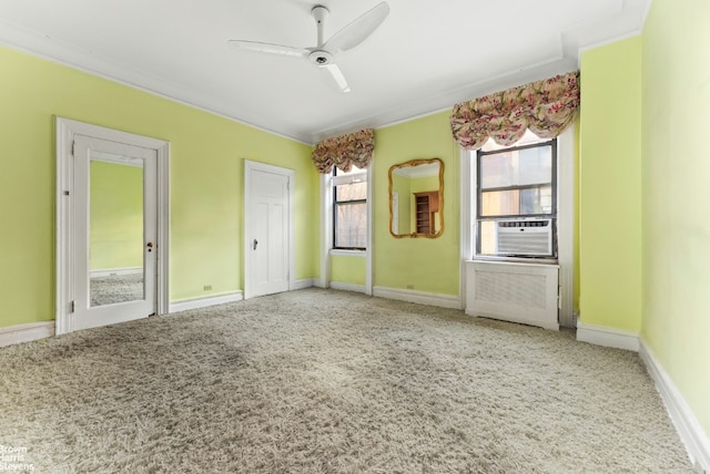 spare room with radiator, carpet, baseboards, and ceiling fan