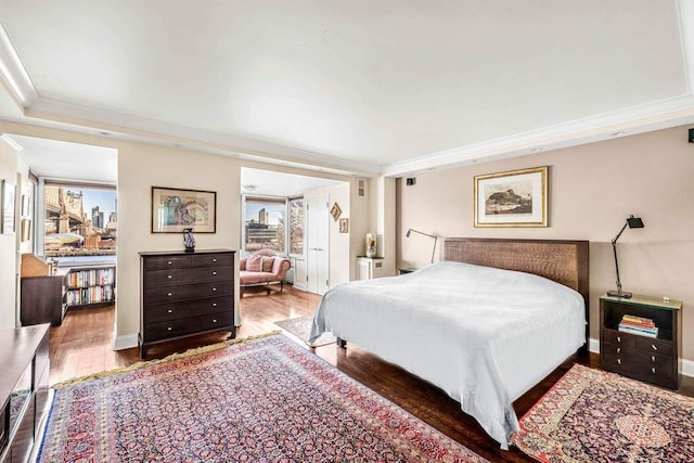 bedroom featuring dark wood-type flooring and ornamental molding