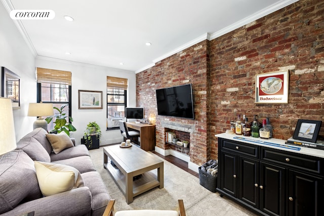 living area featuring brick wall, ornamental molding, light wood-style flooring, and visible vents