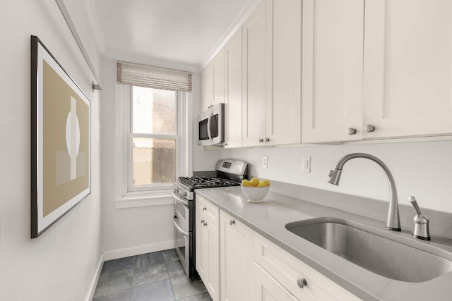 kitchen featuring sink, ornamental molding, white cabinets, and stainless steel appliances