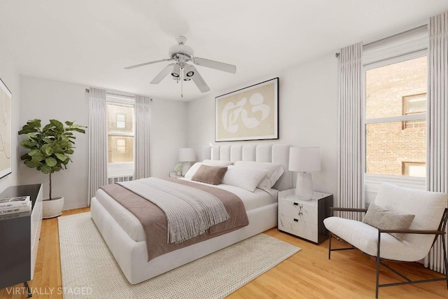 bedroom featuring light hardwood / wood-style flooring and ceiling fan