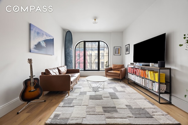 living room featuring wood finished floors and baseboards