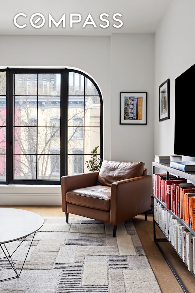 living room with healthy amount of natural light and wood finished floors
