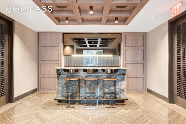 bar with coffered ceiling and beamed ceiling