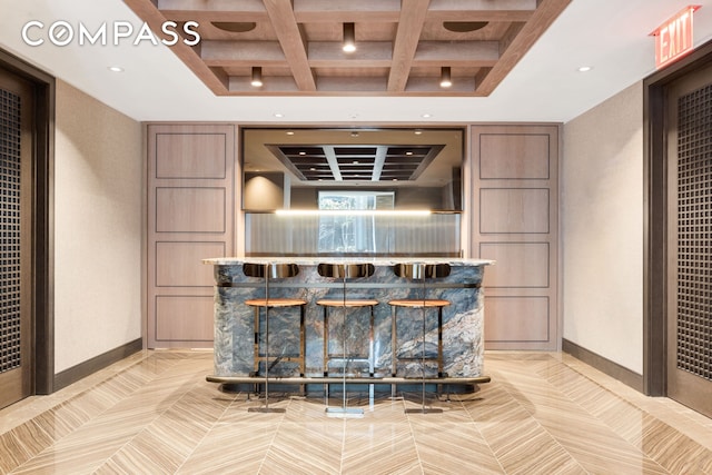 515 W 18th St Unit 210, New York City, NY 10011 - bar with coffered ceiling, beamed ceiling, recessed lighting, and a raised ceiling