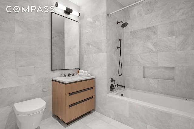 515 W 18th St Unit 210, New York City, NY 10011 - full bath with tile walls, tiled shower / bath, vanity, and tile patterned floors