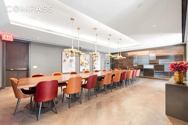 515 W 18th St Unit 210, New York City, NY 10011 - dining space with a chandelier, a raised ceiling, and recessed lighting