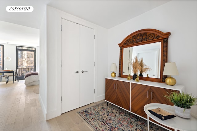 foyer entrance with light wood-style flooring and visible vents