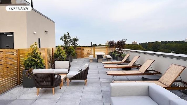 view of patio featuring an outdoor hangout area and fence