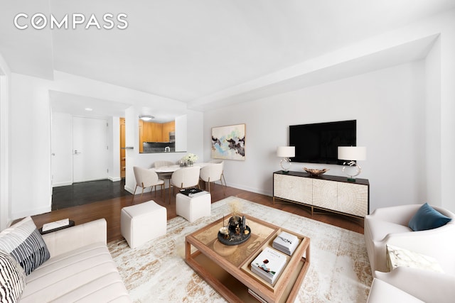 living room featuring baseboards and wood finished floors