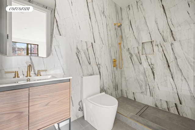 bathroom featuring tile patterned flooring, toilet, a tile shower, tile walls, and vanity