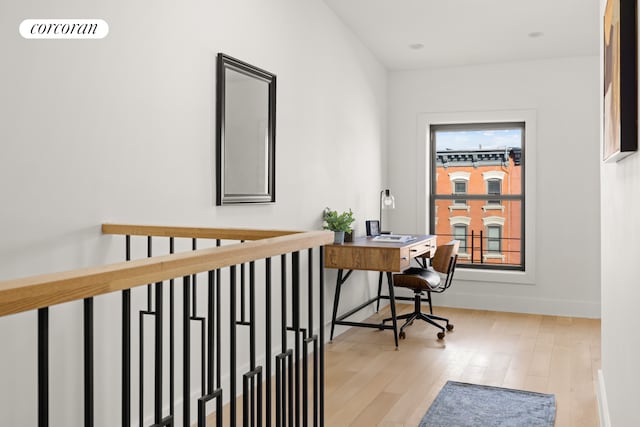office area featuring baseboards, visible vents, and wood finished floors