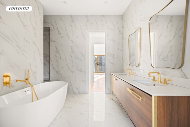 bathroom with vanity and a washtub