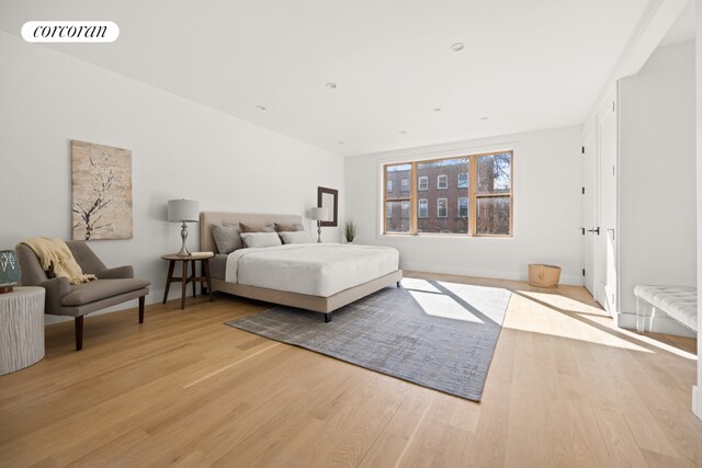 bedroom featuring light wood finished floors and visible vents