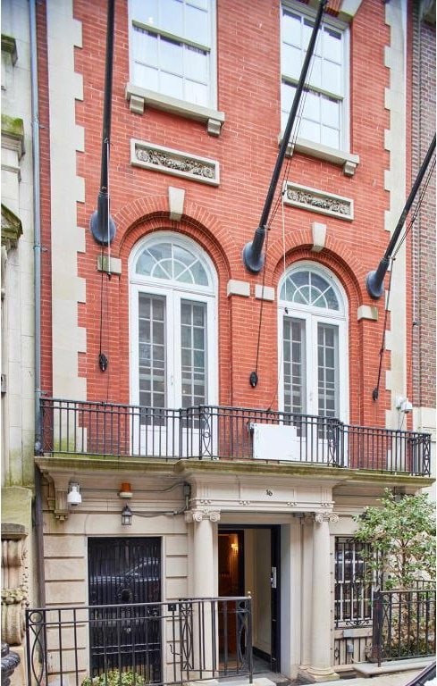 property entrance featuring french doors and a balcony