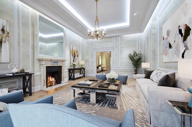 16 E 76th St, New York City, NY 10021 - living room with a chandelier, a high end fireplace, a raised ceiling, and crown molding