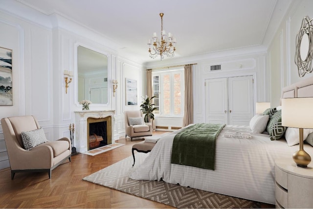 bedroom featuring a notable chandelier, ornamental molding, parquet floors, and a closet