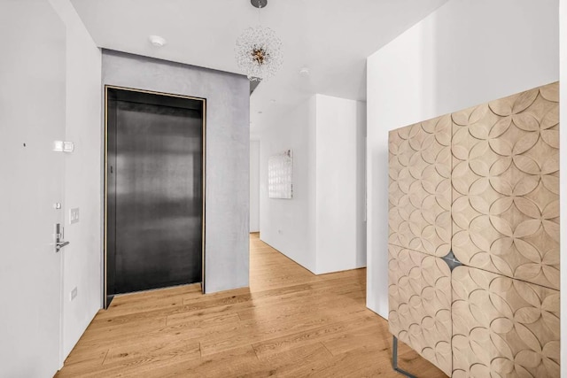 interior space featuring light hardwood / wood-style floors and elevator