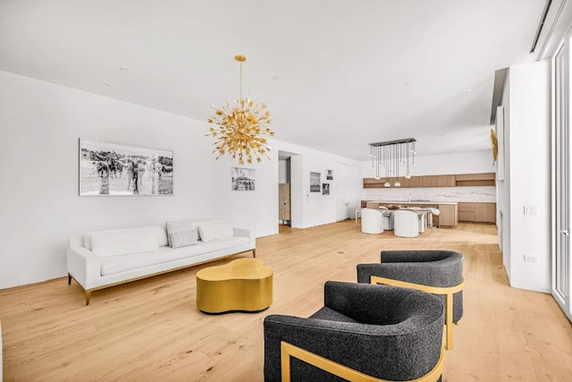 living room featuring light hardwood / wood-style floors and a chandelier