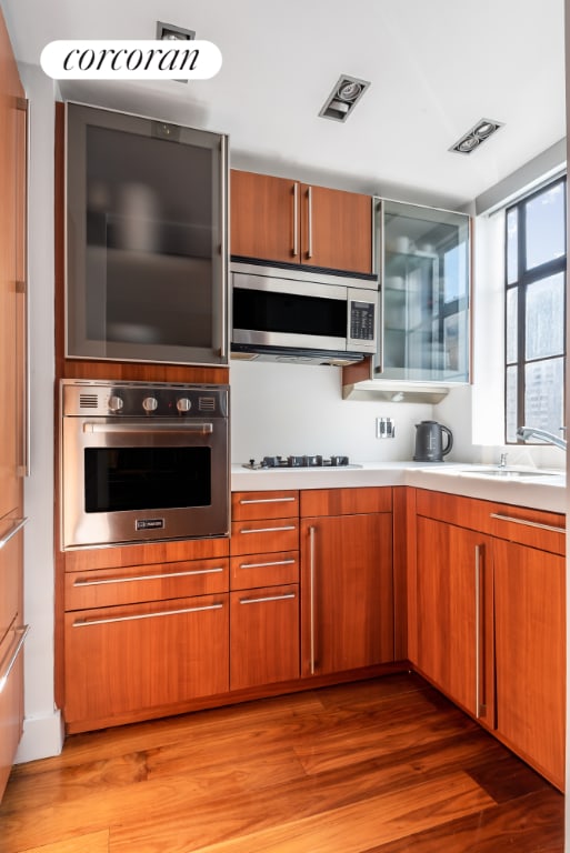 kitchen featuring hardwood / wood-style floors, stainless steel appliances, and sink