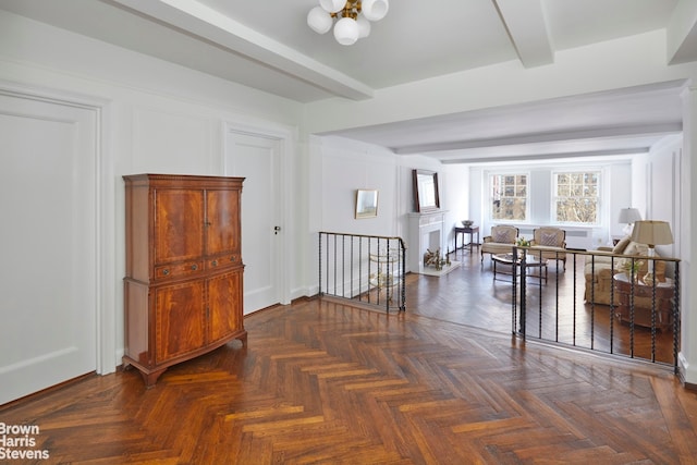 interior space with beam ceiling and dark parquet floors