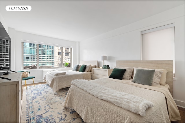 bedroom featuring visible vents and wood finished floors