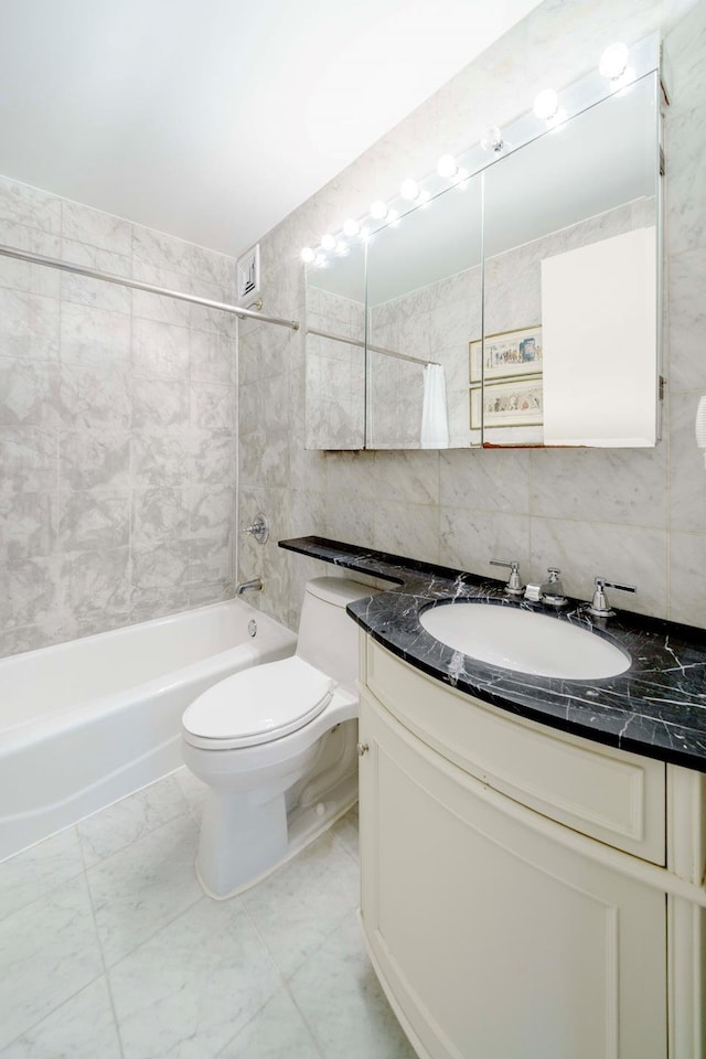 30 W 61st St Unit 21B, New York City, NY 10023 - bathroom with tile walls, toilet, vanity,  shower combination, and tasteful backsplash