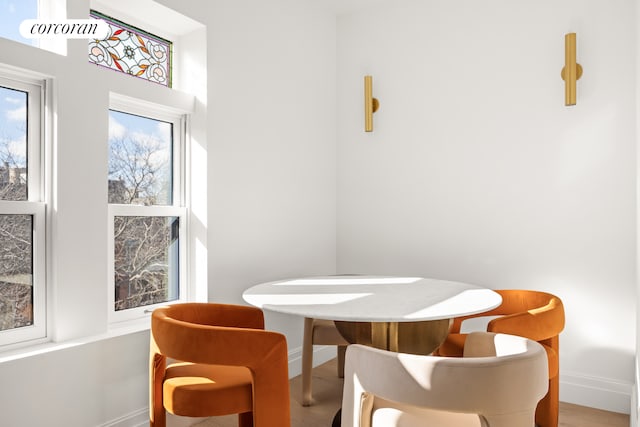 dining room featuring baseboards and wood finished floors