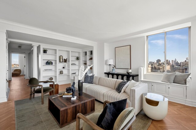 living room featuring a city view and ornate columns