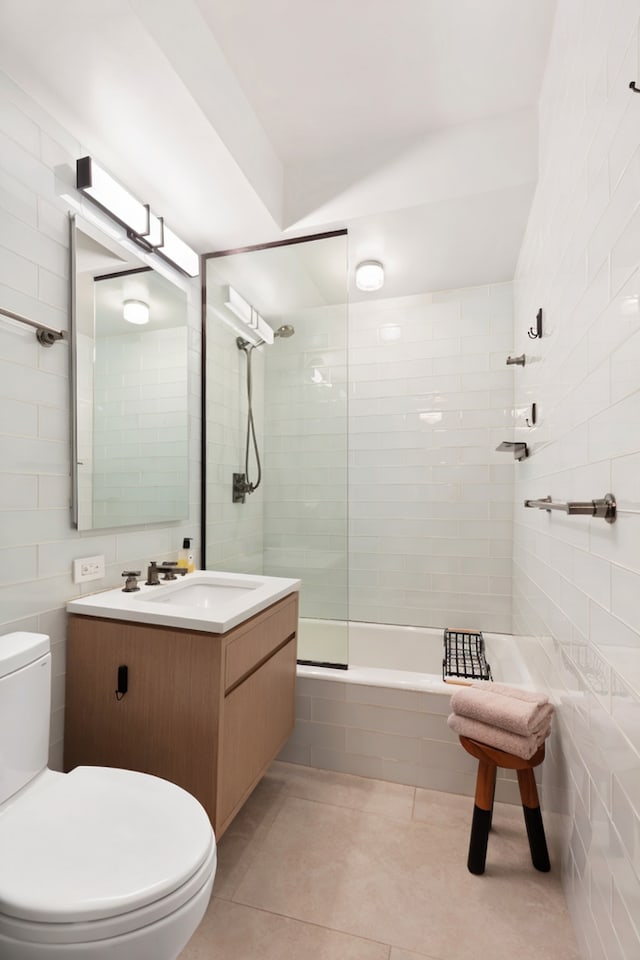 35 E 85th St Unit 2Fg, New York City, NY 10028 - full bathroom featuring tile walls, tile patterned floors, tiled shower / bath combo, and vanity