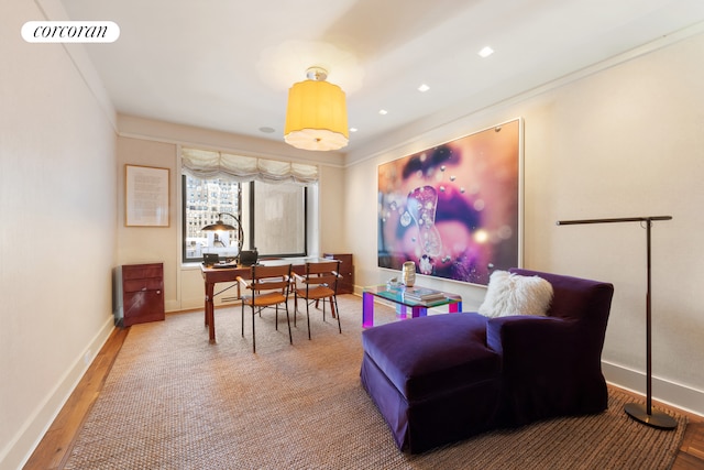 living area featuring visible vents, baseboards, and wood finished floors