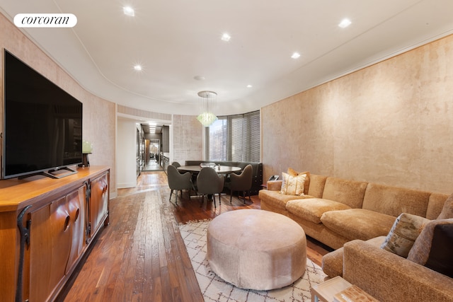 living room with hardwood / wood-style floors and visible vents