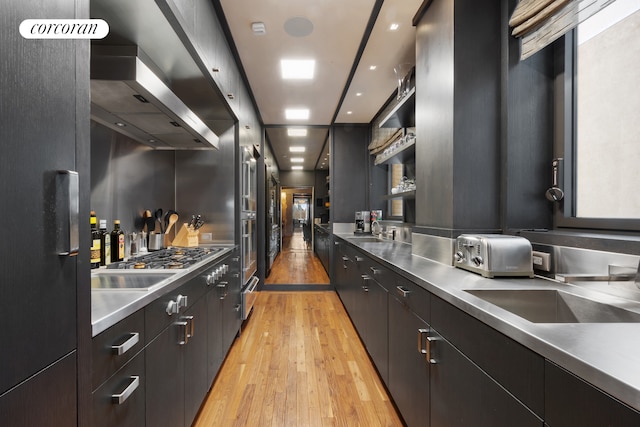 kitchen featuring open shelves, stainless steel countertops, stainless steel appliances, light wood-type flooring, and a toaster