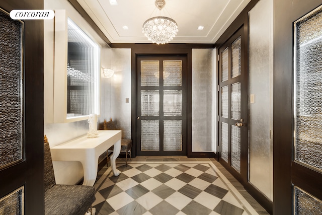 mudroom with an inviting chandelier, a wealth of natural light, and light floors