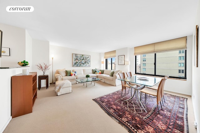 living area with baseboards, visible vents, and carpet flooring