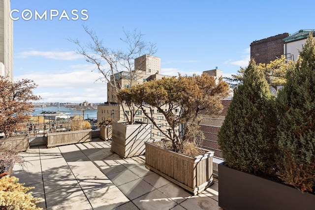 view of patio with a water view