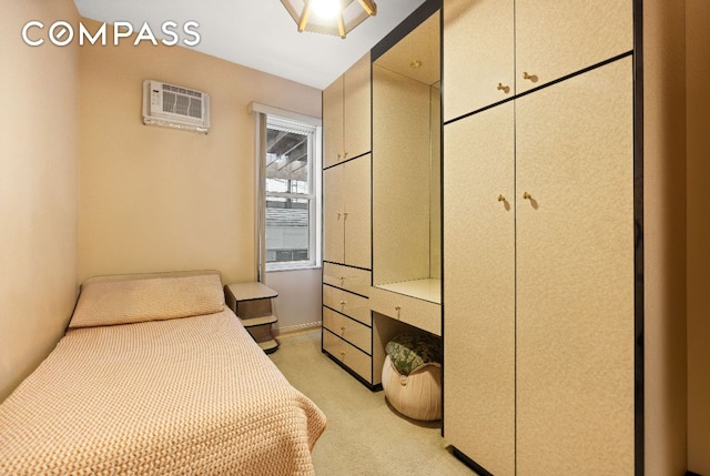 bedroom with a wall unit AC and light colored carpet