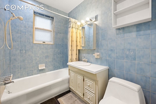 full bathroom featuring tile patterned flooring, toilet, vanity, tile walls, and shower / bath combo