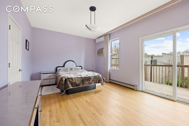 bedroom with light wood-style floors, access to outside, multiple windows, and baseboard heating