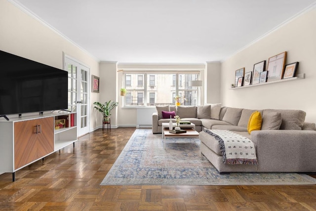 living room with ornamental molding and baseboards