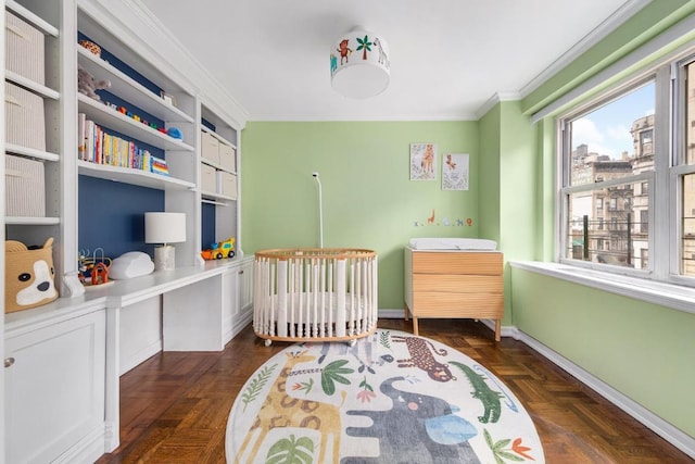 bedroom with a crib, baseboards, and crown molding