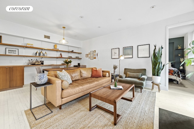 living area featuring light wood-style floors, visible vents, and recessed lighting