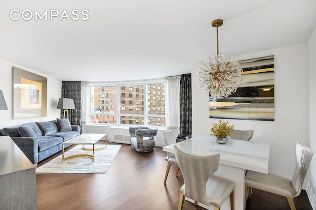 living room featuring a notable chandelier and wood finished floors