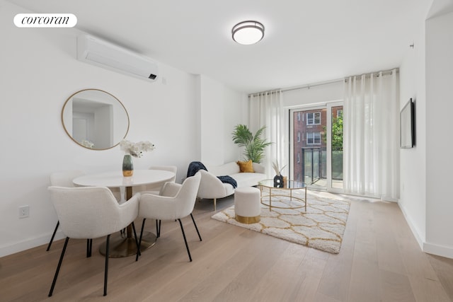 428 E 9th St Unit 703, New York City, NY 11218 - dining space featuring a wall mounted AC, wood finished floors, and baseboards
