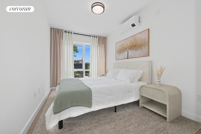 428 E 9th St Unit 703, New York City, NY 11218 - bedroom with an AC wall unit, baseboards, and carpet