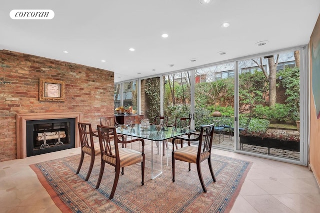 dining room with visible vents, light tile patterned floors, a wall of windows, a fireplace, and recessed lighting