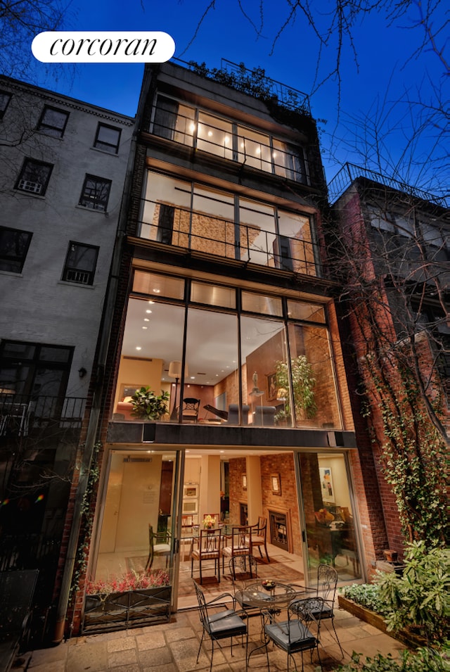 back of house with a patio area and a balcony