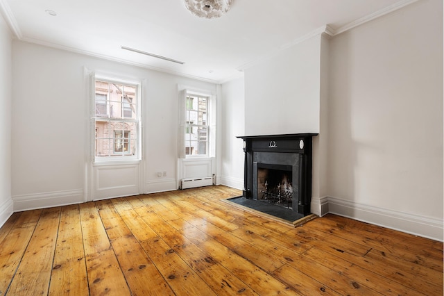 unfurnished living room featuring a baseboard radiator, a fireplace, visible vents, ornamental molding, and wood-type flooring