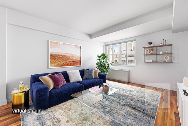 living area featuring baseboards and wood finished floors