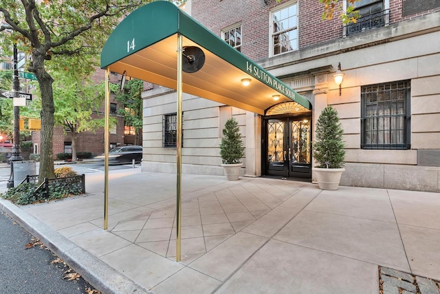 14 Sutton Pl S Unit 13F, New York City, NY 10022 - view of exterior entry featuring french doors and brick siding